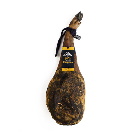 Whole cured Ibérico acorn-fed shoulder (paleta) from La Hoja del Carrasco with a black and gold label and dark cord